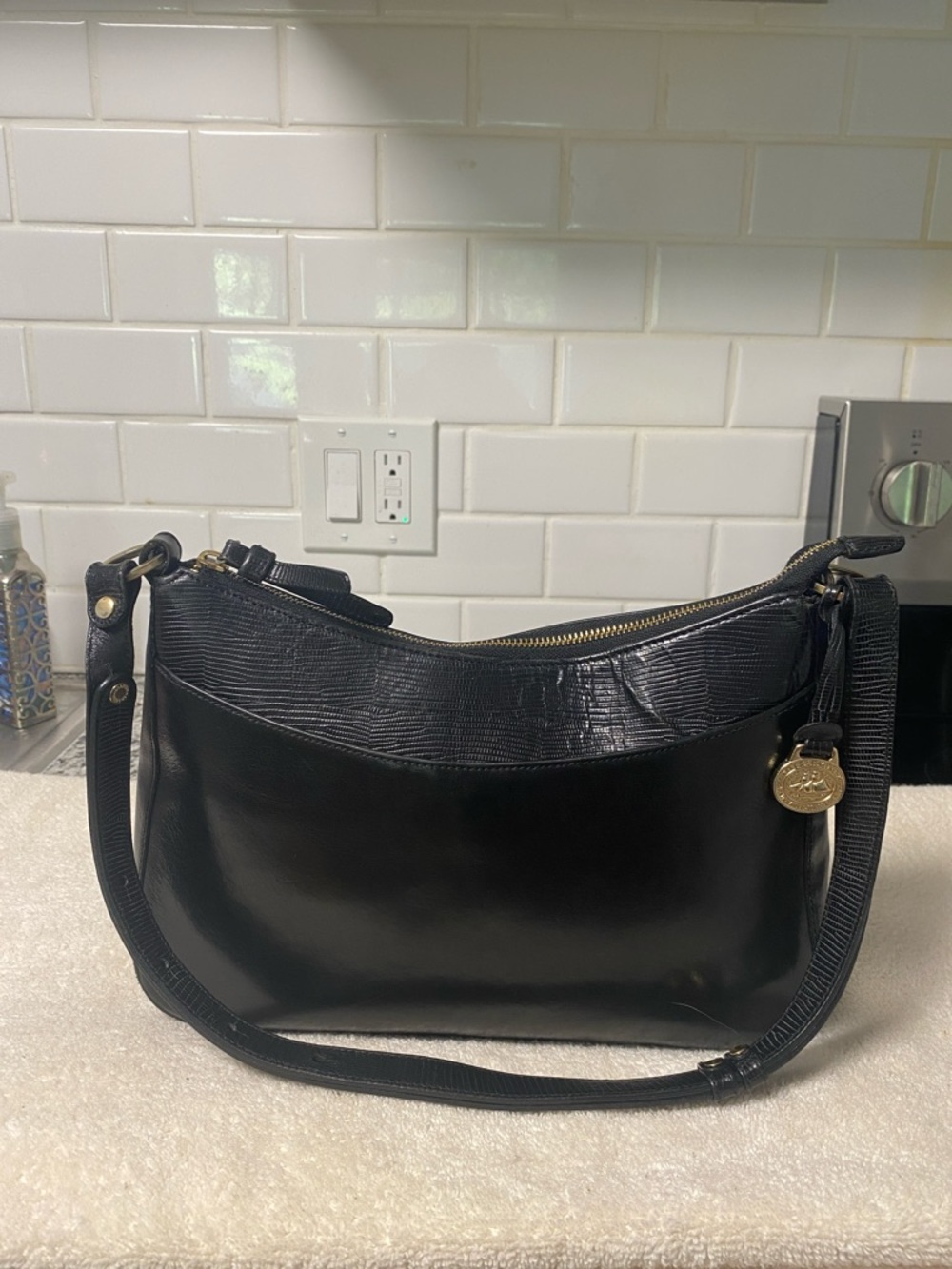 Brahmin Black Leather Shoulder Bag with Textured Trim and Gold Charm
